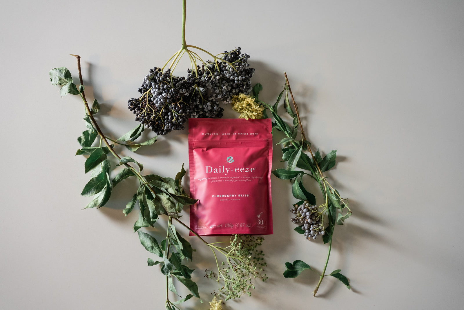Daily-eeze pouch surrounded by fresh elderberries on the branch