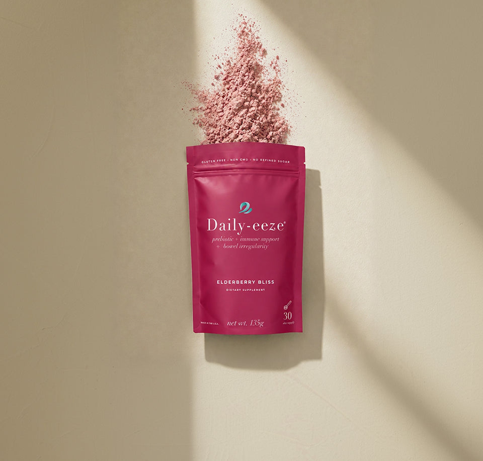 Pink 'Daily-eeze' supplement package with elderberry powder on a beige background