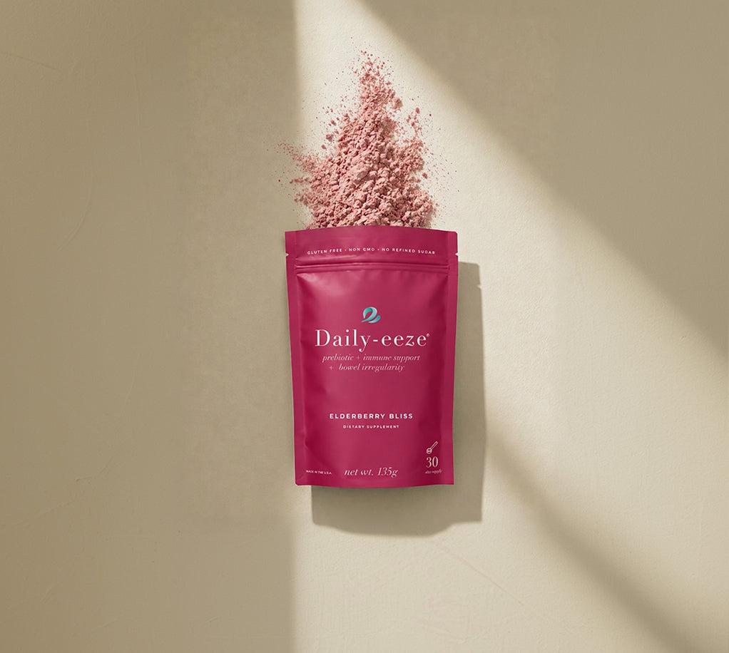 Pink 'Daily-eeze' supplement package with elderberry powder on a beige background